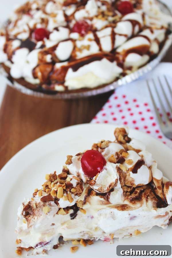 No-Bake Banana Split Pie Recipe 2 a slice of banana split pie topped with chocolate syrup, peanuts, and a cherry.