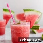 Frozen Watermelon Rose Wine Slushies 4 A short glass with watermelon rosé slushie with a watermelon wedge and pink polka dot straw.