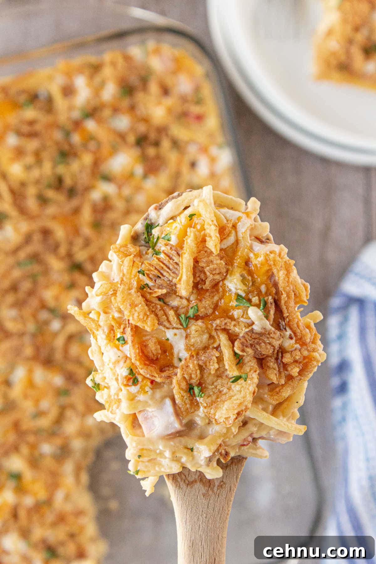A serving of ham tetrazzini being lifted from the dish.