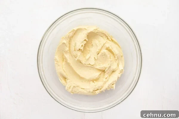 Classic Butter Cookies Recipe for Tea Time 7 Butter cookie dough with flour added in a glass mixing bowl.