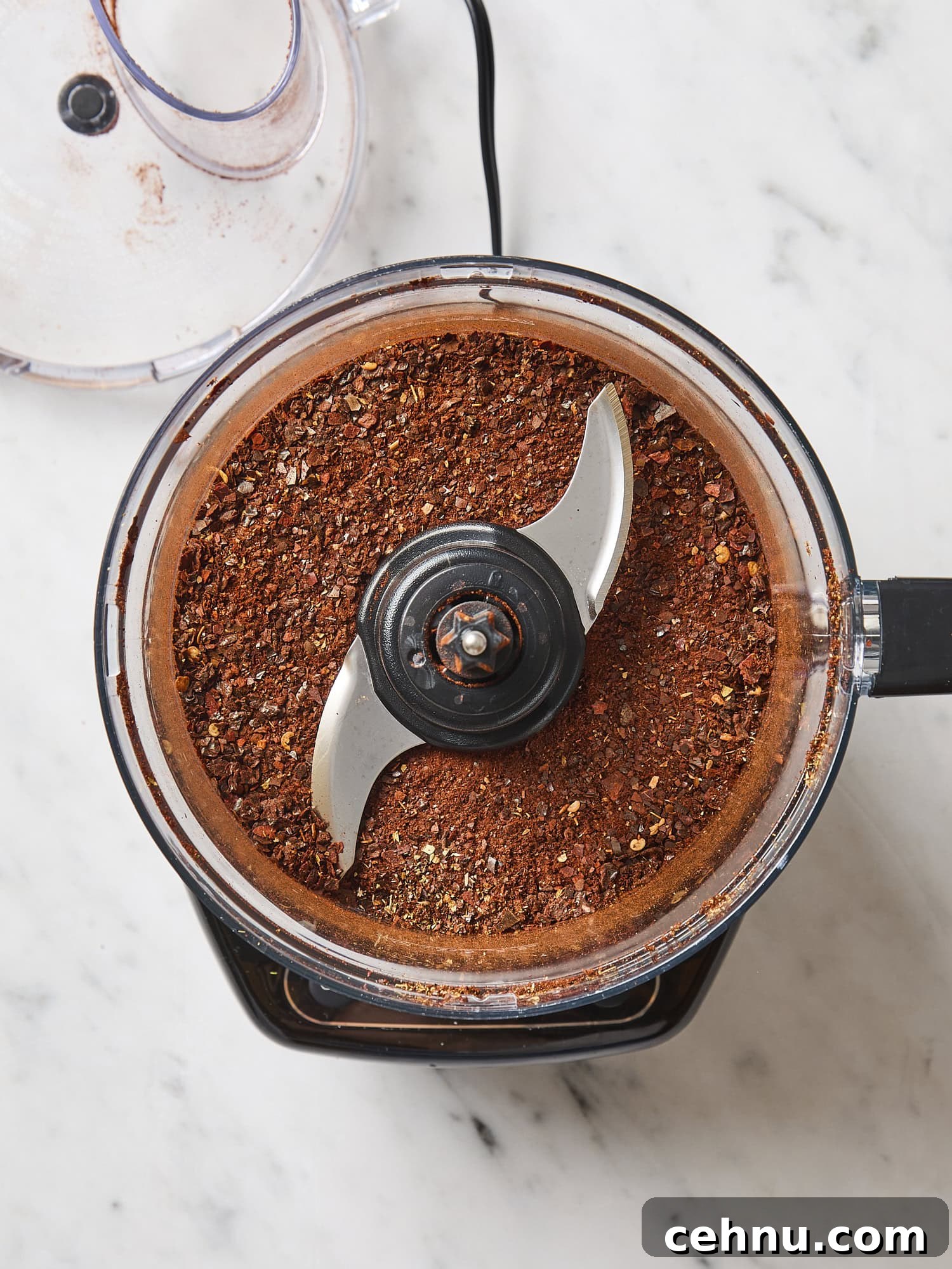 Homemade chili powder in a food processor after being ground up.