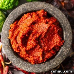A stone bowl with homemade Thai red curry paste.