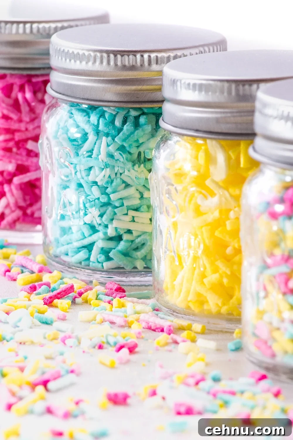 How to Make Sugar-Free Sprinkles for Low-Carb Baking 3 Jars of colourful sugar-free sprinkles on a white background
