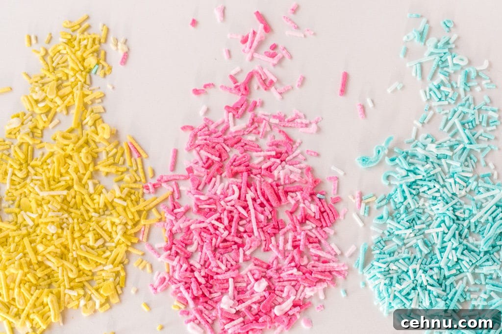 How to Make Sugar-Free Sprinkles for Low-Carb Baking 7 yellow, pink and blue sugar-free sprinkles spread on a white background
