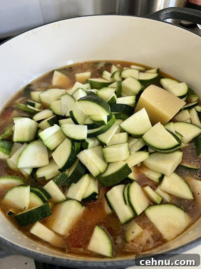 Cut pieces of zucchini just added to pot with cheese rind.