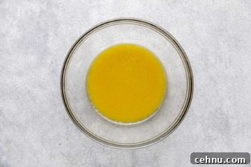 Oil, vinegar, honey mustard mixed in a bowl.