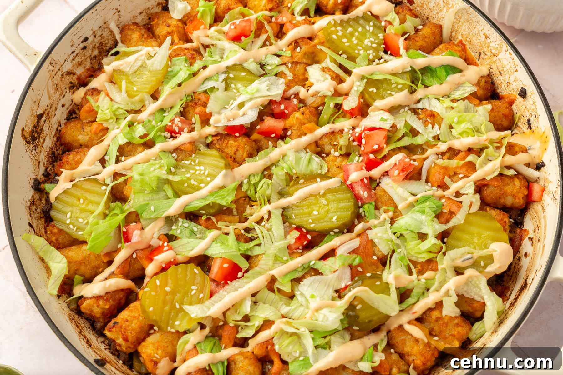 A large round braising pan with big mac casserole in it.