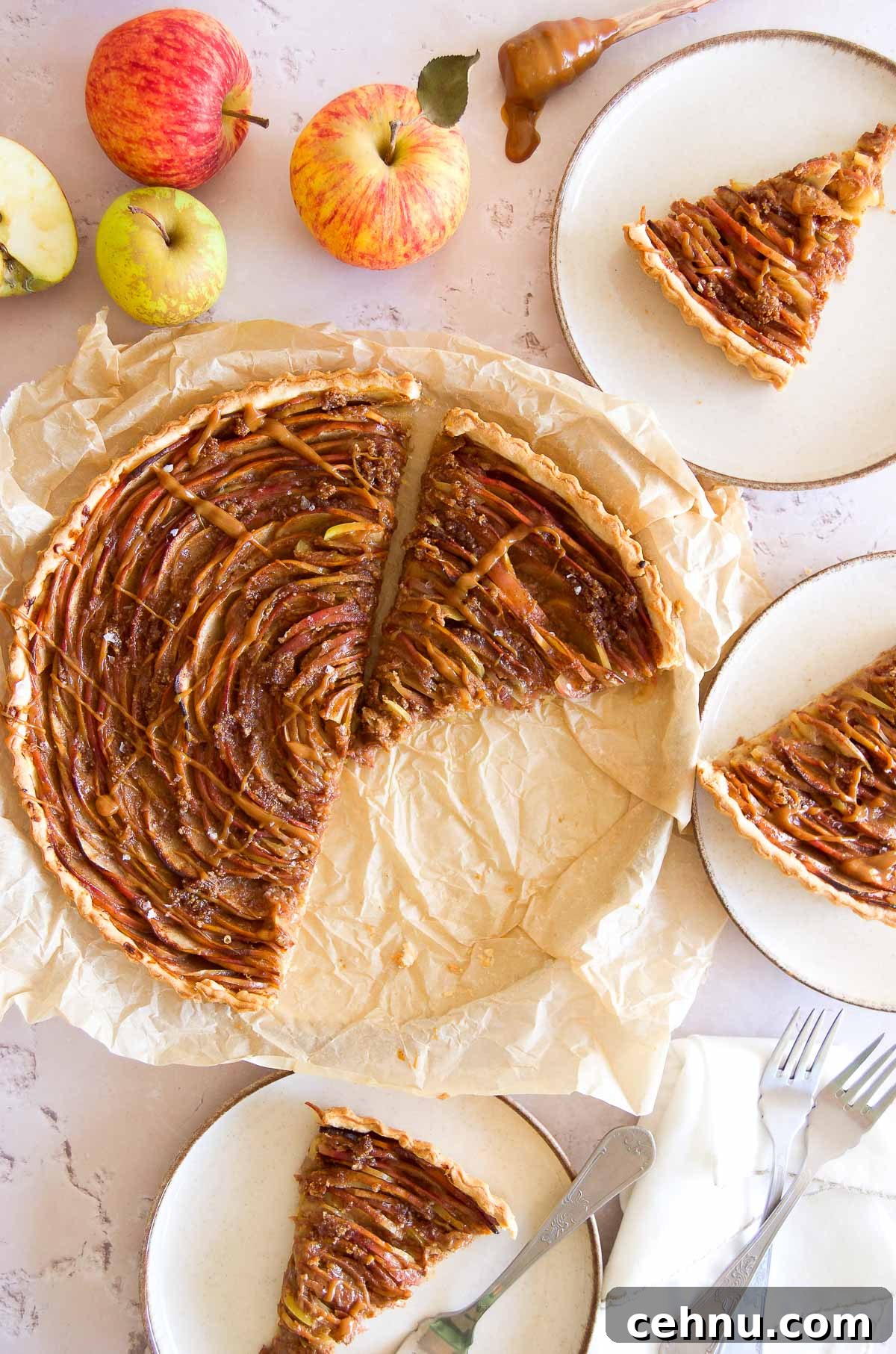 Apple Rose Tart with Dulce de Leche 8 slices of dulce de leche apple tart on plates next to the sliced tart