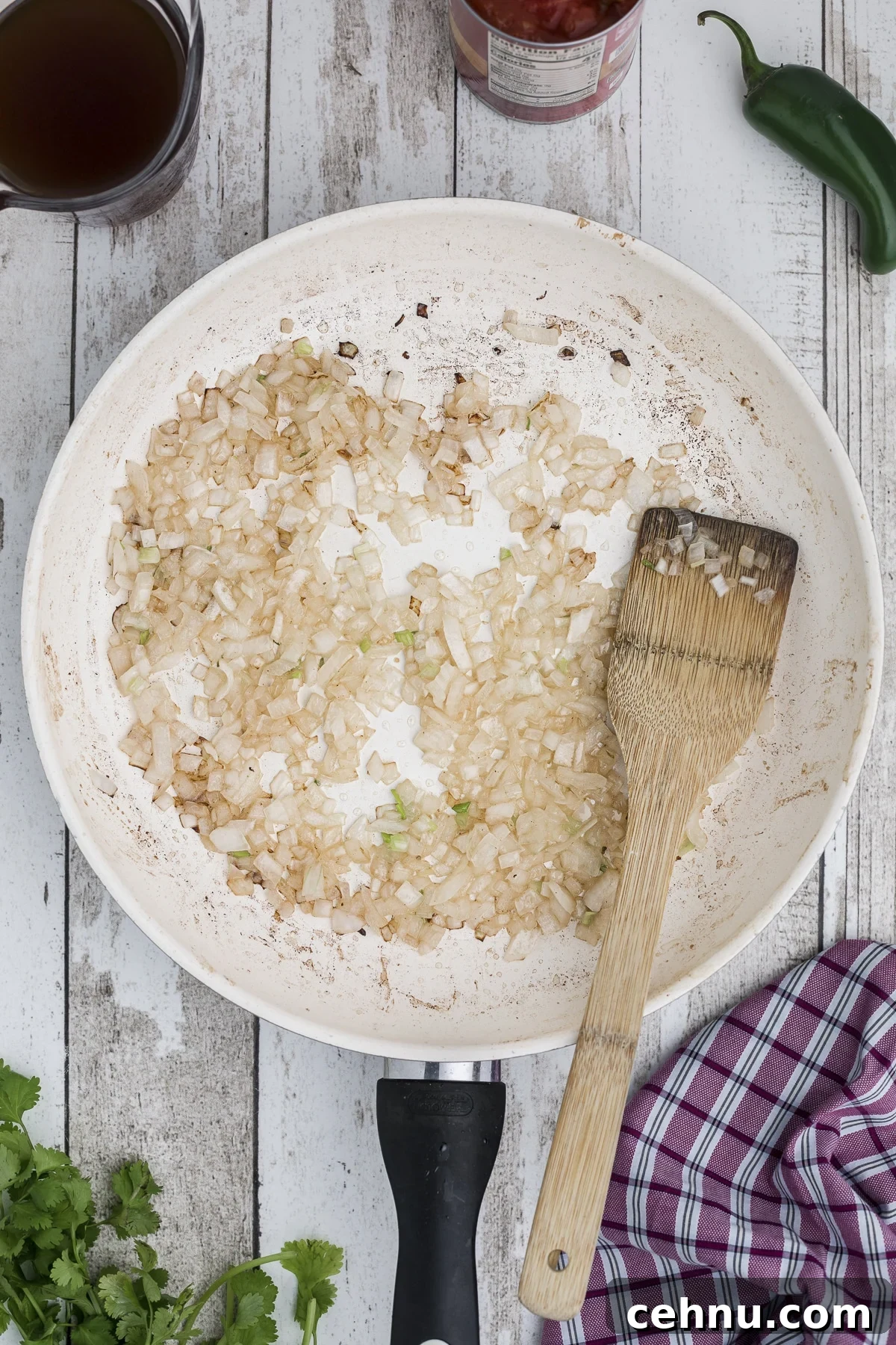 Onions being sauted in a skillet.