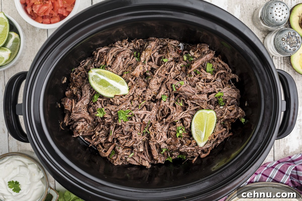 mexican shredded beef in slow cooker with 2 limes on top