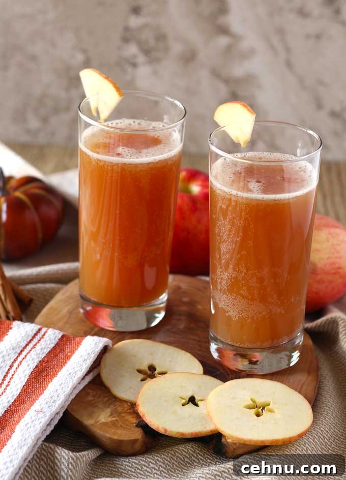 Two glasses of shandy garnished with apple slices