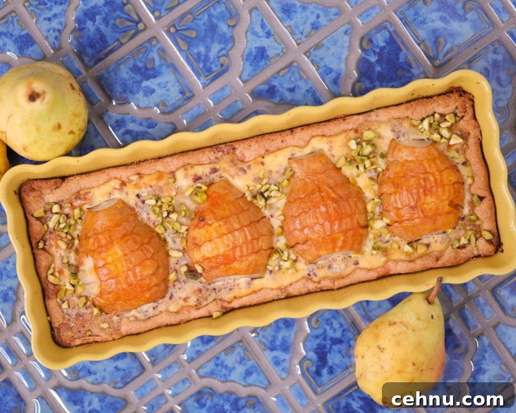 Pear and frangipane tart in a long yellow pan.