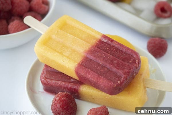 Homemade Peach and Raspberry Popsicles Recipe 13 stack of popsicles made with berries and peaches