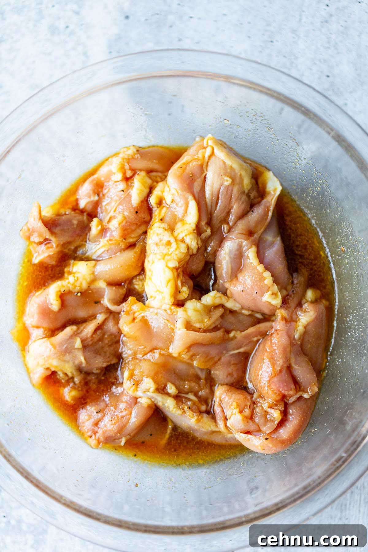 Crispy Honey Garlic Chicken Thighs in the Air Fryer 5 chicken thighs in a bowl with marinade