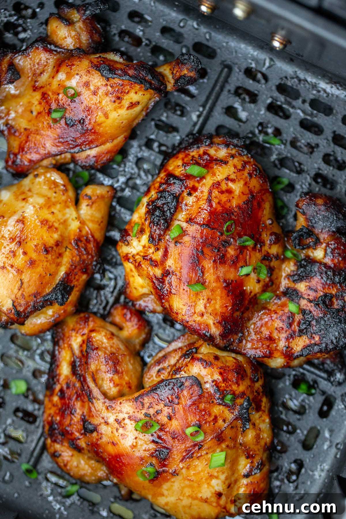 Crispy Honey Garlic Chicken Thighs in the Air Fryer 6 cooked chicken thighs in air fryer basket