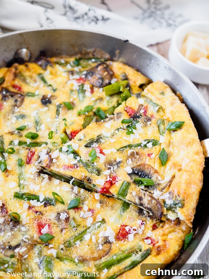 Vegetable Frittata with Spinach and Cherry Tomatoes 3 Close-up of a Healthy Vegetable Frittata in a skillet.