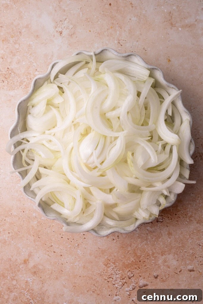 5 yellow onions that have been peeled, cored, and sliced thin.