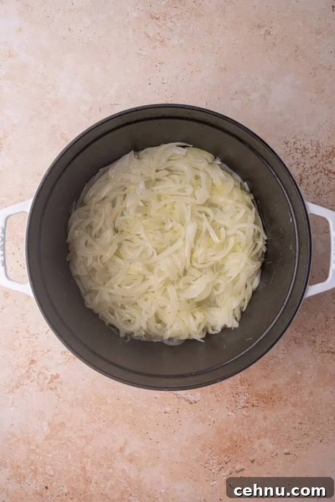 Cooking sliced onions down in a large cocotte in butter.