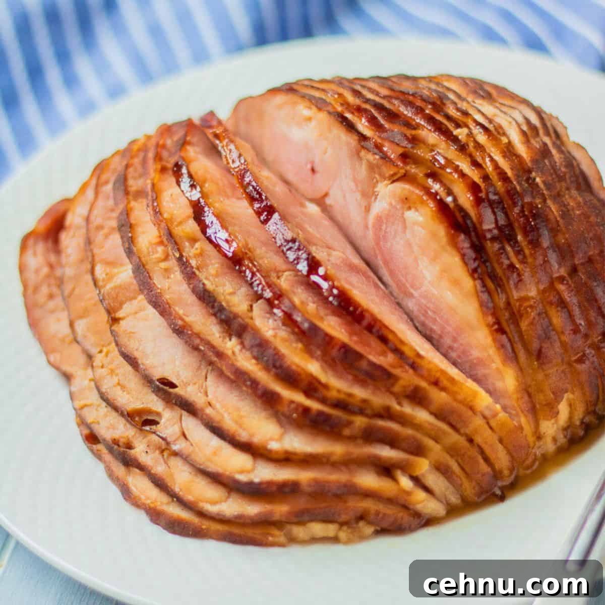 Instant Pot spiral sliced ham glazed in honey pineapple glaze on white platter next to electric pressure cooker.