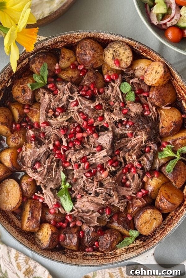 slow cooked lamb with potatoes in a tray.